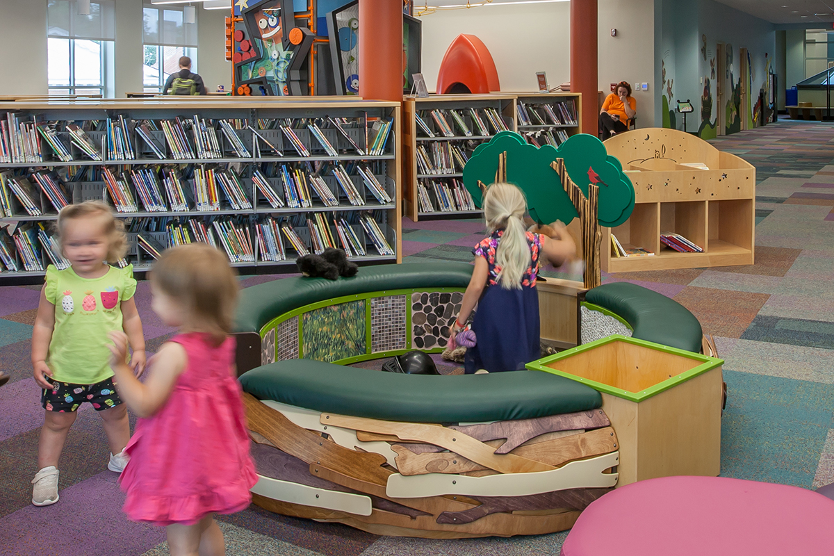 girl playing in a tot spot nest structure